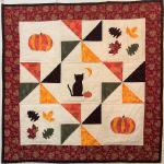 Made using yardage - 1/4 yard of 4 colors for appliques and pinwheels, 1/2 yard of background, and 1/2 yard for the border